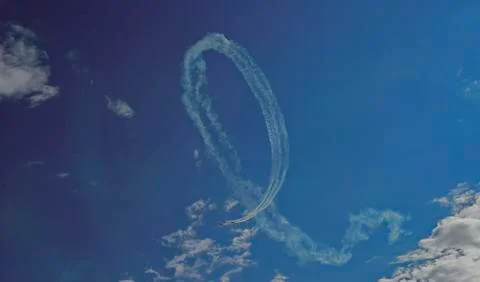 Inversion trail of the plane. A small plane makes a dead loop. Stock Photos