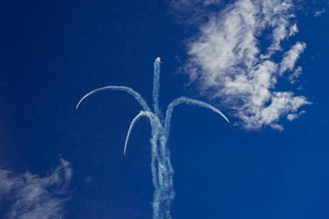 Inversion trail of the plane. A small plane practices aerobatics Stock Photos