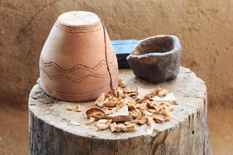 Inverted ceramic pot standing on a tree stump with dried mushrooms Stock Photos