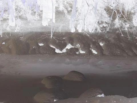 Inverted colors - Beautiful partially transparent ice on frozen river under Stock Photos