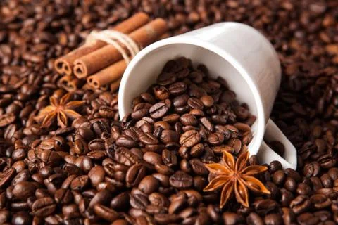 Inverted cup with coffee beans Stock Photos