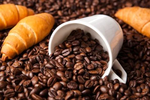Inverted cup with coffee beans Stock Photos