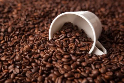 Inverted cup with coffee beans Stock Photos