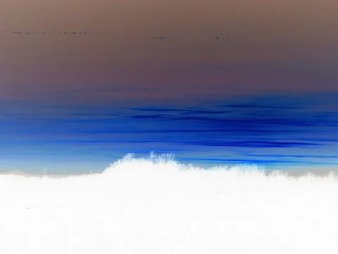 Inverted image - Beautiful dusk over dark horizon with colored layers of clouds. Stock Photos