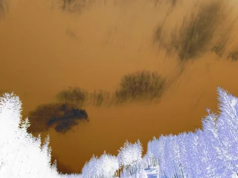 Inverted image - Beautiful sparse clouds on a blue sky over mountain forests. Stock Photos