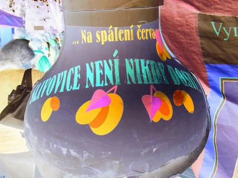 Inverted image - Close-up view on a giant plum brandy bottle with funny writing Stock Photos