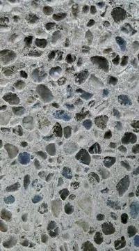 Inverted image - Pebbly pattern background, pebbles embedded in concrete. Stock Photos