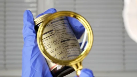 Investigating ingredients of medicines using magnifying glass, gloved hand Stock Footage 126990570