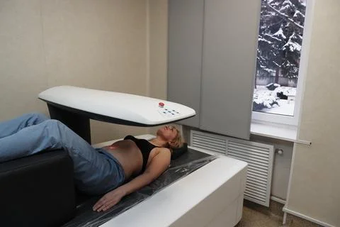 Investigation of the density of human bones using an osteodensitometry apparatus Stock Photos