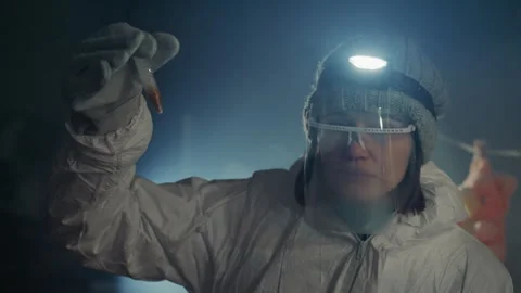 Investigator examines illuminated sample within abandoned house. Scientist in Video stock 342742689