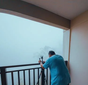 Investigator or private detective or reporter or paparazzi setting tripod for Stock Photos