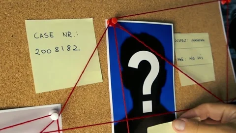 Investigator placing cold case sticky note on crime board Stock Footage 342044498
