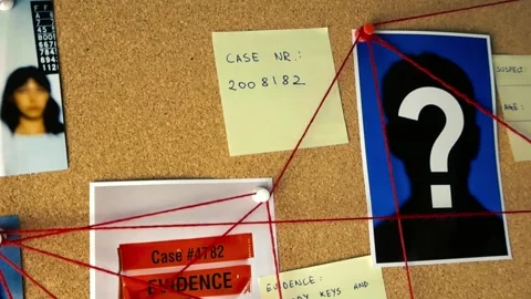 Investigator placing an unsolved sticky note on a crime board Stock Footage 343933578