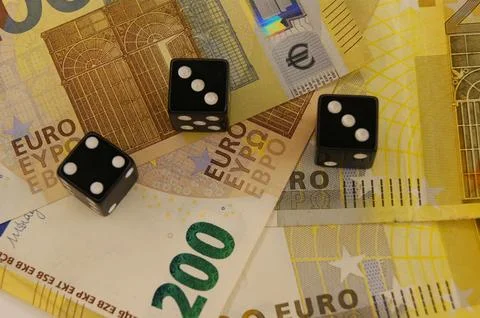 Investment with risks concept Three dice on 200 euro banknotes. Stock Photos