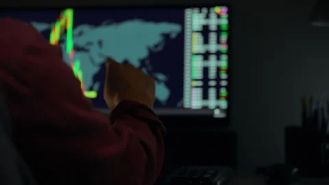 Investor analyzing market trends while monitoring global financial data at n Stock Footage 323866211