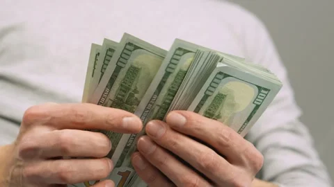 The investor carefully studies banknotes, emphasizing the importance his Stock-Footage 247472271