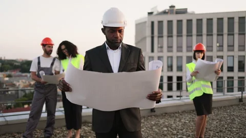 Investor posing at camera while colleagues inspecting object Stock Footage 246132205