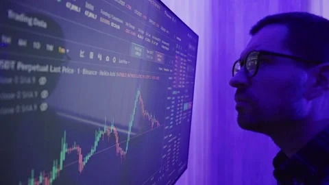 Investor stock trader comparing dynamic financial exchange rate data on screen Stock Footage 274378022