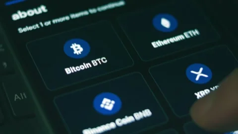 Investor using smart phone and computer analyzing financial data crypto stock Stock Footage 249937223