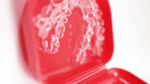 Invisalign clear aligner in red containe... | Stock Video | Pond5