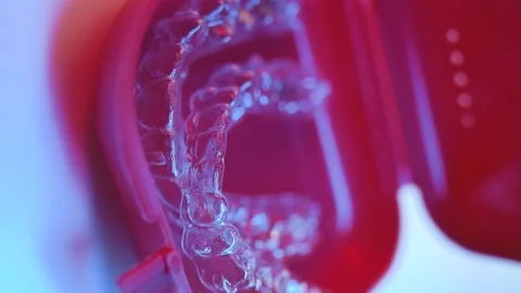 Invisalign clear aligner in red containe... | Stock Video | Pond5