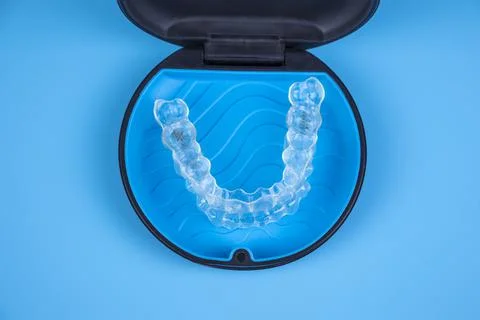 Invisalign transparent braces in a plastic case. Orthodontic invisible retainers Stock Photos