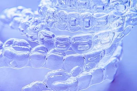 Invisible aligner teeth retainers on a blue background Stock Photos