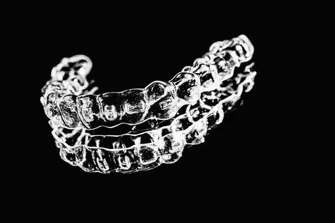 Invisible aligner teeth retainers lie on the mirror in orthodontic office. Ph Stock Photos
