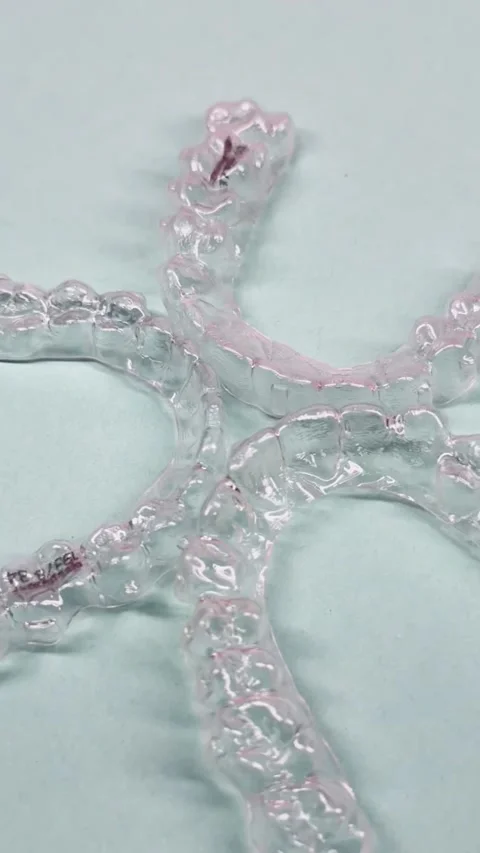Invisible dental teeth brackets tooth aligners on blue background. Plastic .. Stock Footage 318591730