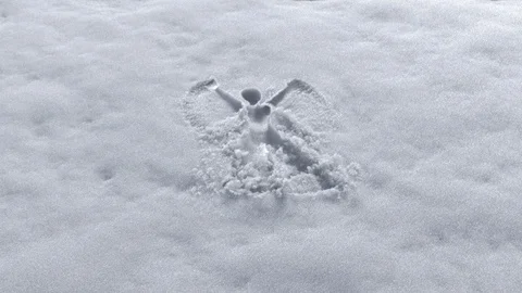 Invisible man making snow angel design on a fresh snow Stock Footage 101439082