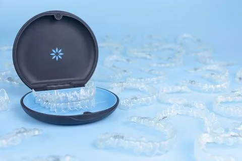 Invisible retainers case with orthodontic aligner brackets. Black plastic dental Stock Photos
