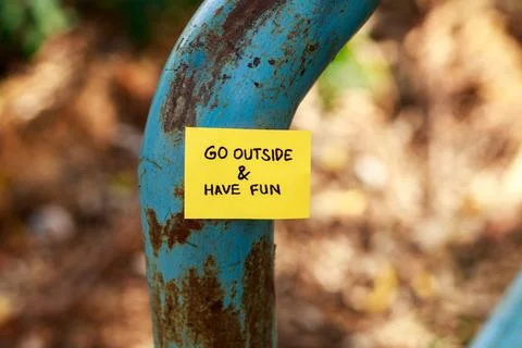 Invitation to go outside, sticky notes attached to park posts Stock Photos