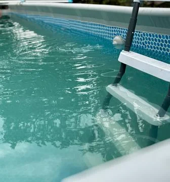 Inviting Backyard Pool with Sturdy White Ladder Stock Photos