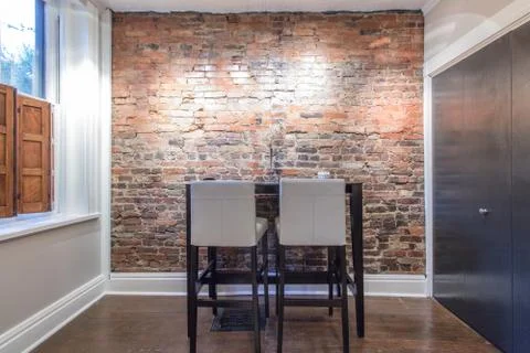 Inviting bar table in front of exposed brick Stock Photos