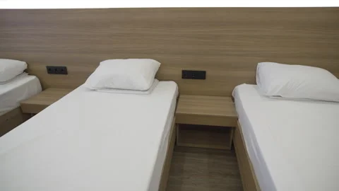 Inviting bedroom with single beds and minimalist furniture Stock Footage 318742033