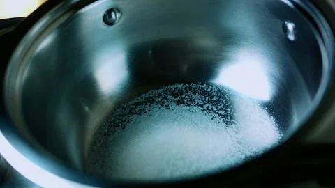 Inviting cooking study of adding liquid to sugar for caramel Stock Photos