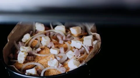 Inviting culinary close-up: arranging the mixture in a baking dish Stock Photos