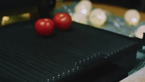 Inviting culinary view of moving fresh tomatoes from a wooden board to the grill Stock Footage 342152649