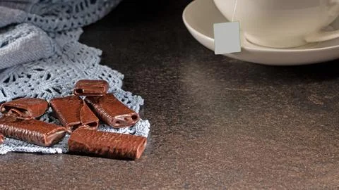 An inviting evening tea setting with delectable chocolate treats and a steami Stock Photos