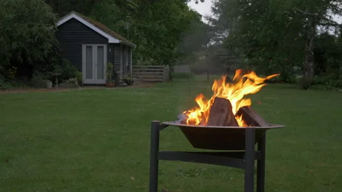 Inviting Fire Pit BBQ with burning wood and ember surrounded by trees Stock Footage 144155167