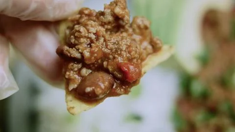 Inviting food study of spoon lifting a hearty bite of chili Stock Photos
