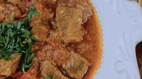 Inviting garnished dish view: showing tender beef in tomato sauce Video stock 342199885