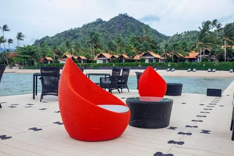 An inviting outdoor seating area with a pristine view of a tranquil beach, .. Stock Photos