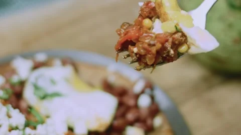 Inviting serving view of huevos rancheros with avocado and roasted pepper Stock Footage 342153099