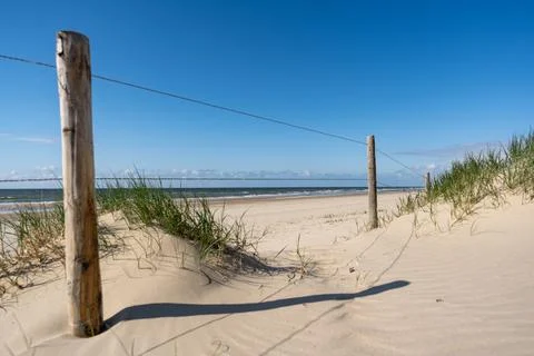 An inviting view of a classic beach access point, featuring a sandy path fram Stock Photos