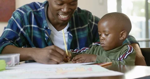 Involved dad colouring with kid Stock Footage 119614363