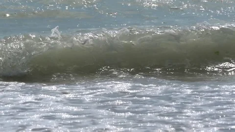 Involved waves running on the blue surface of the ocean and breaking off shor Stock Footage 77649738