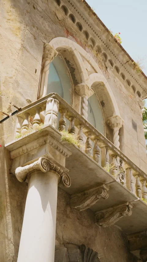 Ionic capital supporting a carved balustrade and pointed arch window in Amalfi Stock Footage 344735107
