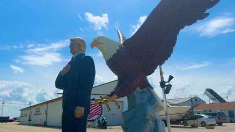 IOWA - 6.24.2024 - Low angle view of an Iowa roadside shrine to Donald Trump, Stock Footage 279711777