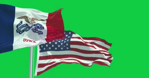 Iowa state flag waving in the wind with the US flag isolated on green backg.. Stock Footage 277942280